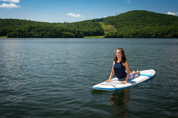 a person riding on the back of a boat in a body of water