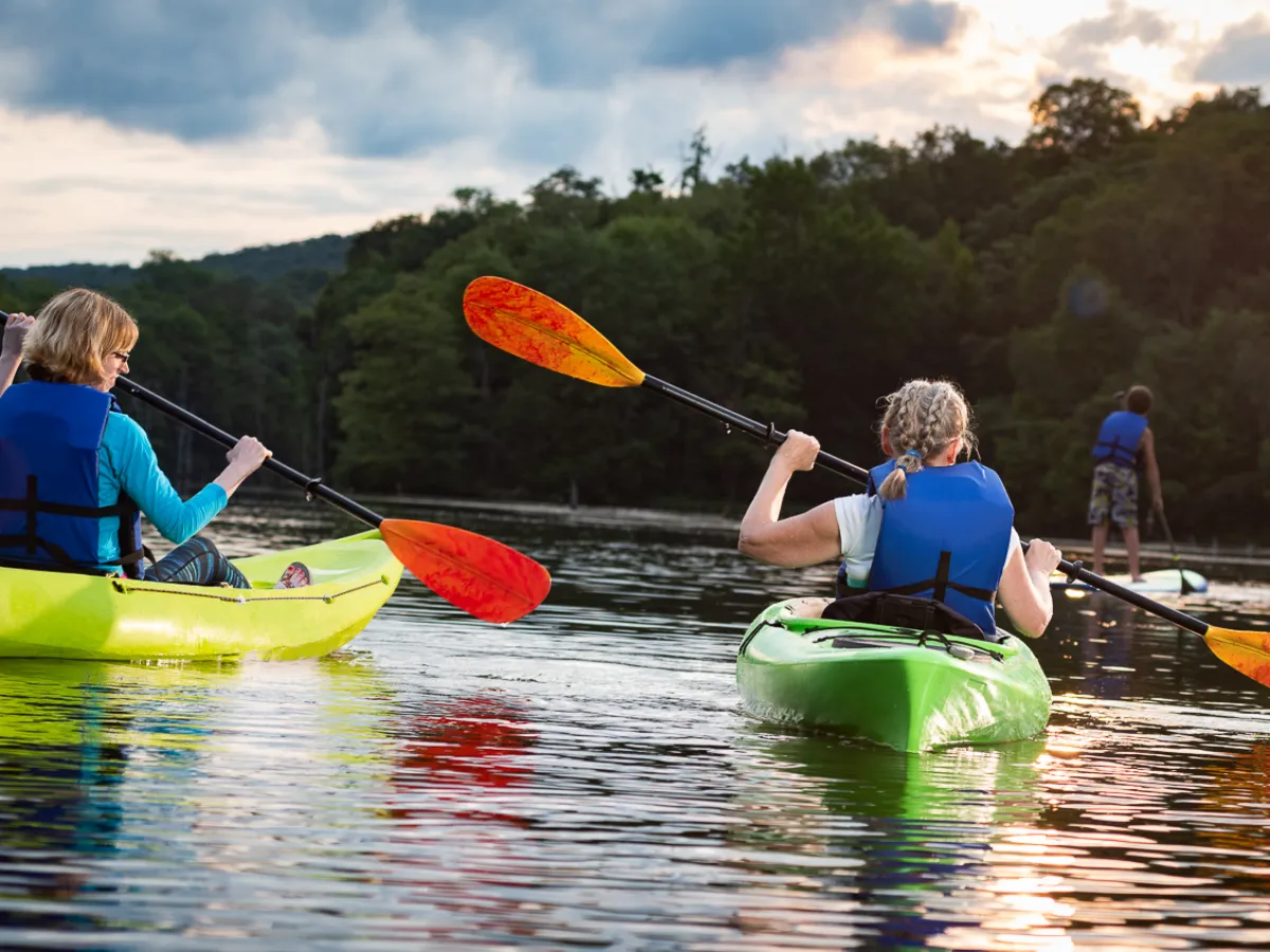 Kayakers and stand up paddleboarders on water
