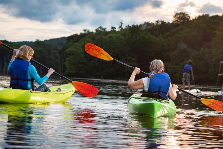 Kayakers and stand up paddleboarders on water