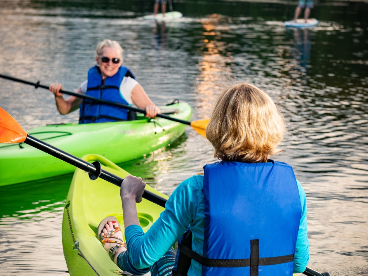 Kayakers and stand up paddleboarders on water