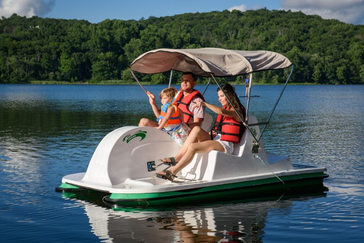a person riding on the back of a boat in a body of water