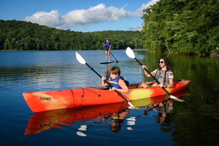 a group of people in a small boat in a body of water