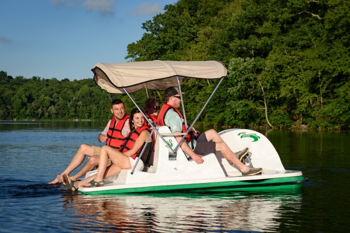 Four people riding on a pedal boat
