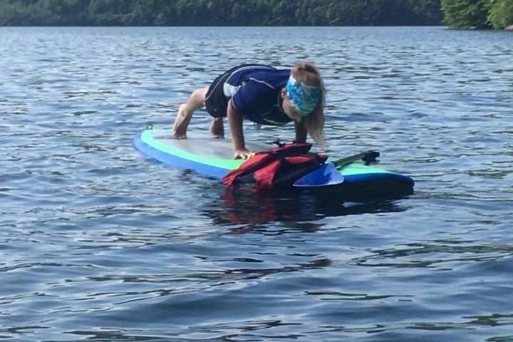 a man riding on the back of a boat in a body of water